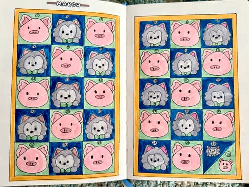 Reviewer's journal showing a March mood tracker made with cute pig and wolf stickers from the subscription.