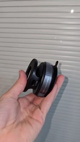 Customer holding the compact 360° MagPro Magnetic Phone Holder in its folded position against a white background.