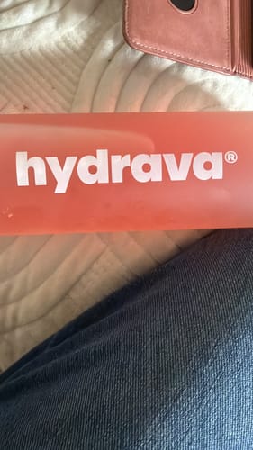 A close-up of the reviewer's pink Frosted Hydrava Bottle, showing the brand logo.