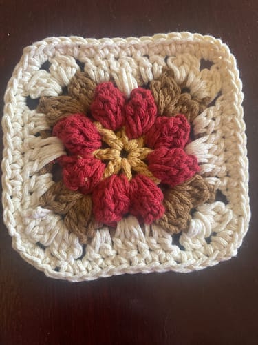 Customer's first completed granny square for the Garden Rose Hobo Kit, showing a colorful 3D rose.