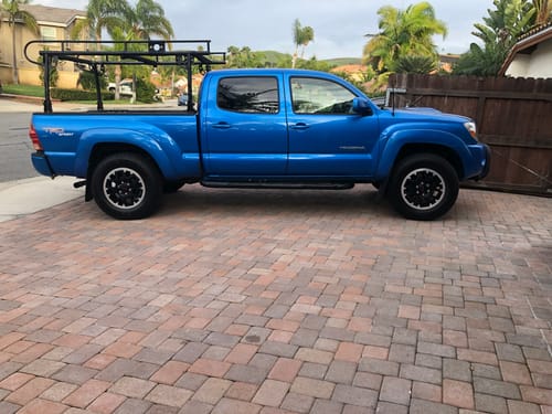 Customer's blue Toyota Tacoma parked on a driveway after installing the RoadActive Suspension Kit.