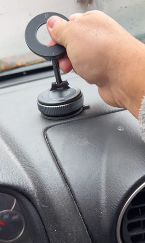Customer adjusting the 360° MagPro Magnetic Phone Holder after installing it on a car dashboard.