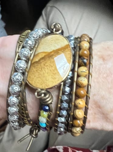 Close-up of a reviewer wearing the Earth Healing Energy Wrap Bracelet, showing the large jasper stone and various beaded strands.