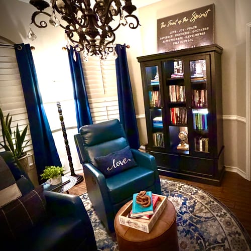 Customer's 'Fruit Of The Spirit' sign displayed above a dark bookcase in a cozy, decorated reading room.