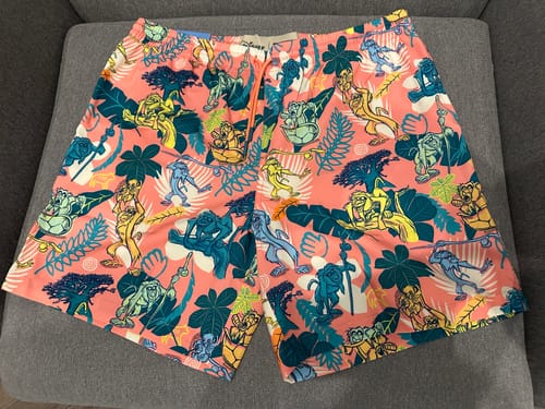 Customer's pink "Peak Rafiki" Hybrid Shorts laid flat, showing the colorful all-over pattern of Rafiki and tropical leaves.