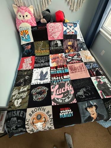 Customer's Premium T Shirt Quilt made from country music t-shirts, spread out fully on a bed.