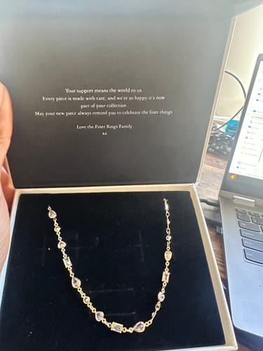 Customer's beautiful Mixed Cluster Gem Necklace with clear gems displayed in its open, elegant packaging box.