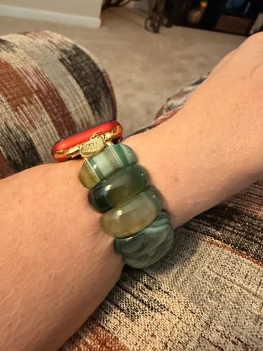 Customer's wrist wearing the Emerald Grove Agate Stretch Apple Watch Strap, showing the large, polished green stones.