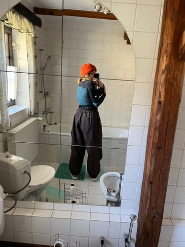 Customer showing the baggy fit of the coffee snow pants from behind.