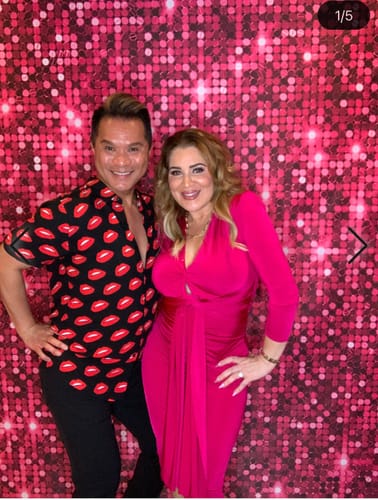 Reviewer posing in the fuchsia pink Alicyn long-sleeve midi dress next to another person.