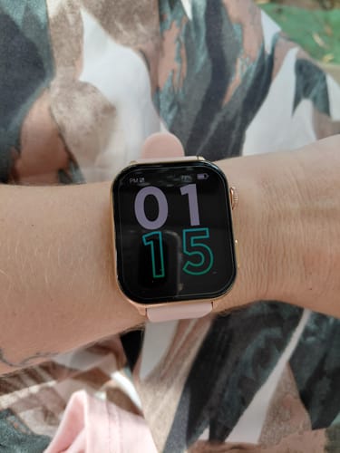 Reviewer wearing the Gard Pro Health Smartwatch 3 with a rose gold case and pink band on their wrist.