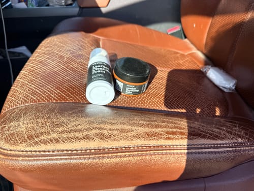 Customer shows Clyde's Recoloring Balm on a cracked and faded brown leather car seat before use.