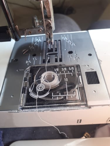 Close-up of the reviewer's new Elna Needle Plate installed on a sewing machine with the bobbin cover on.