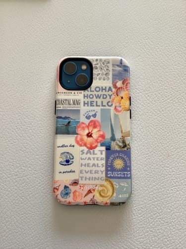 Customer's phone in the stylish Coastal case, which features a detailed beach-themed collage.