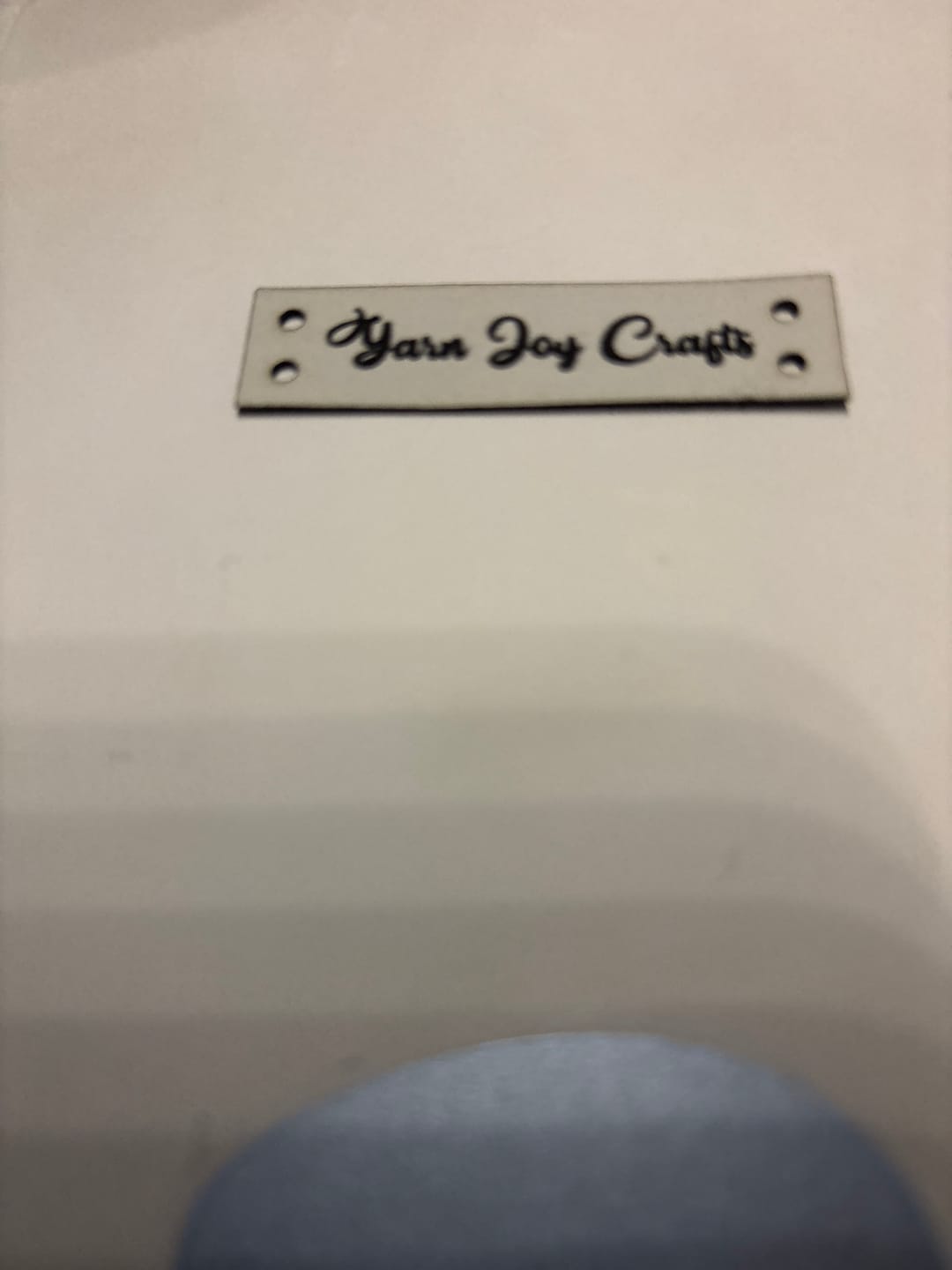 Customer photo review of Custom Faux Leather Tags - Sew-On Rectangle Labels - 2 x 0.5 Inch for Handmade Projects
