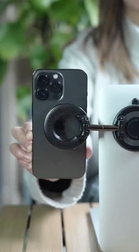 Customer showing the black 360° MagPro Magnetic Phone Holder mounted on a laptop, securely holding a phone.