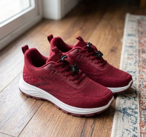 Customer's red Secure Walk 2.0 shoes with a convenient no-tie design, shown indoors on a wood floor.