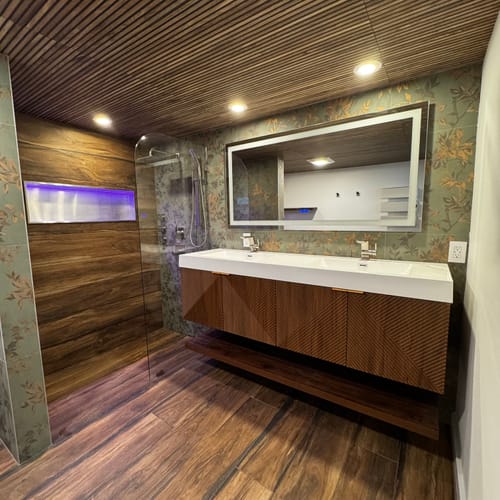 Reviewer's modern bathroom featuring the Leuven Floating Vanity with a double sink and a glass-enclosed shower.