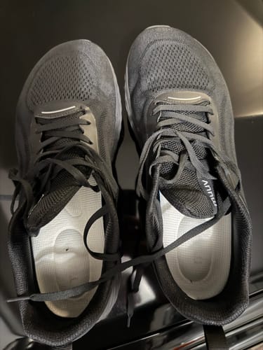Customer's Extra Cushion Insoles placed inside a pair of black sneakers.