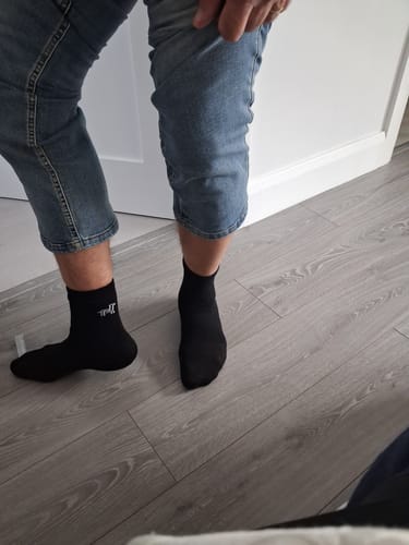 Customer wearing a pair of black Crew Socks, showing the fit.
