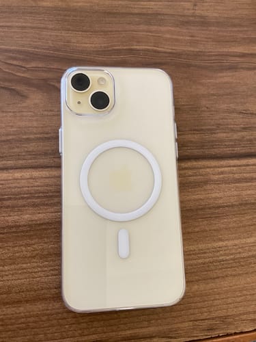 Customer's Anti Yellow Magsafe Transparent Clear Case on an iPhone, showing the white MagSafe ring on a wooden surface.