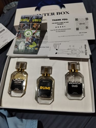 Reviewer's OUD Supreme BUNDLE unboxed, showing three different fragrance bottles in a white presentation box.