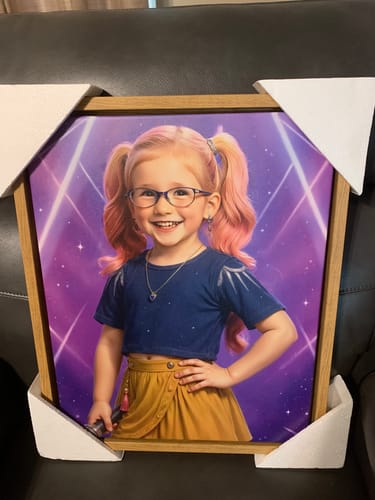 Customer's framed K-Pop Queen The Pink Comet portrait of a smiling girl with pink hair, shown in its protective packaging.