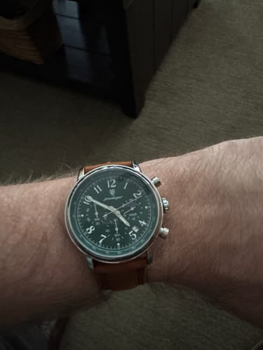 Customer's Lucky Fours® Shoreline watch shown on their wrist with a dark green dial and a brown leather strap.