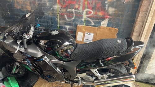 Customer's black, textured Wind Rider Seat Cover installed on their Honda motorcycle.