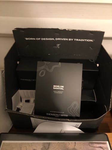 Customer's open black box showing the packaging for their Bois De Santal Eau de Parfum.