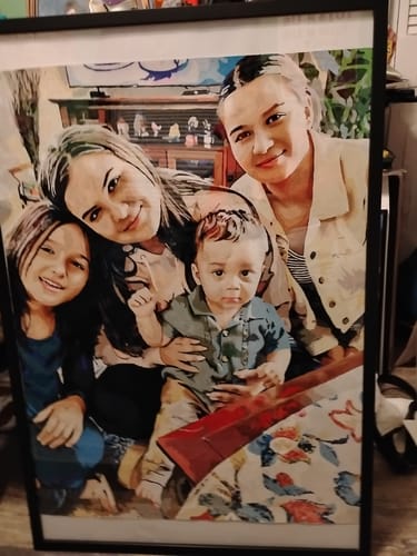 Customer's finished Custom Paint By Numbers Kit showing a framed, detailed portrait of a family.