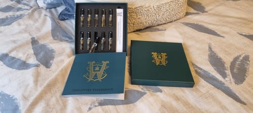 Customer's open green Discovery Set box with small perfume vials and a matching booklet.