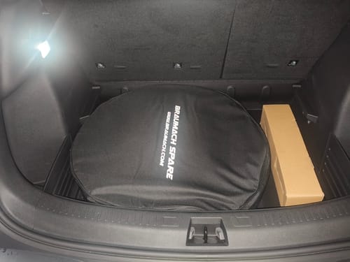 Reviewer's Braumach Spare Wheel Kit with its black bag fitting snugly in the trunk of a BYD ATTO 2.