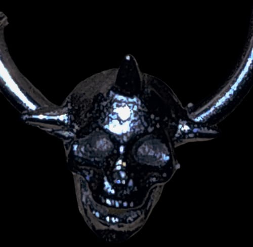 Close-up: A reviewer's dark REAL 6TH CIRCLE OF HELL SEPTUM showing the detailed skull and spike design.