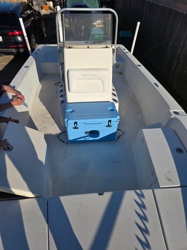 Customer's light blue cooler placed on the deck of a boat, showing how well it fits.