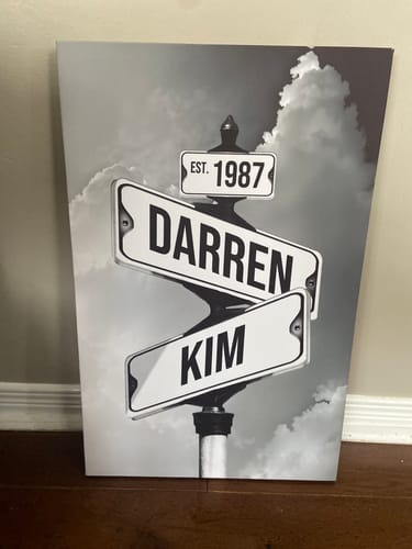 Customer's personalized black-and-white canvas showing street signs with the names 'Darren', 'Kim', and the year '1987'.