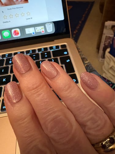 Customer showing their Holy Gels manicure in a sparkly pink shade, worn for three weeks.