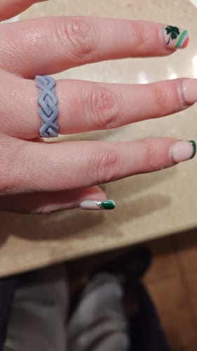 Reviewer wearing the comfortable, grey braided silicone ring on their finger.