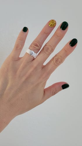 Reviewer showing their hand wearing the white Silicone Ring with a round solitaire CZ stone.