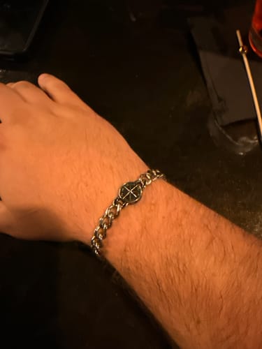 Customer's wrist, showing the stylish Navigator’s Cuban Link Bracelet with its compass charm.