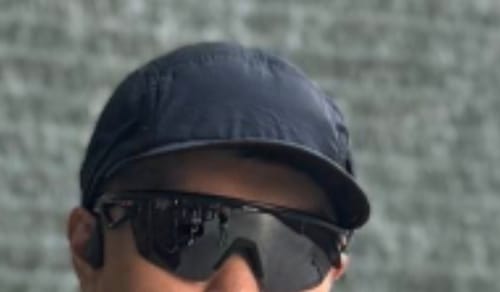 Reviewer wearing the dark Ciele GOCap Solar Elite Running Cap in a close-up photo.