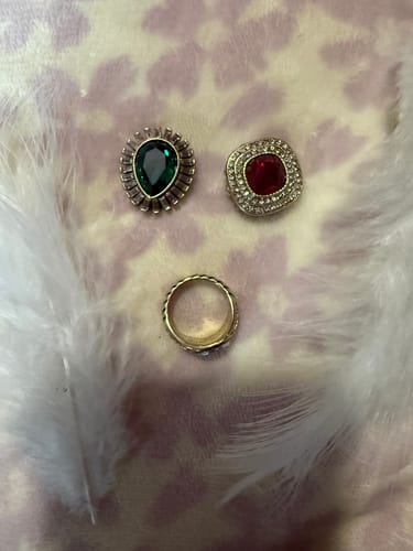 Customer's 'Enchante' magnetic ring set showing the gold band and two of three interchangeable tops on a fluffy surface.