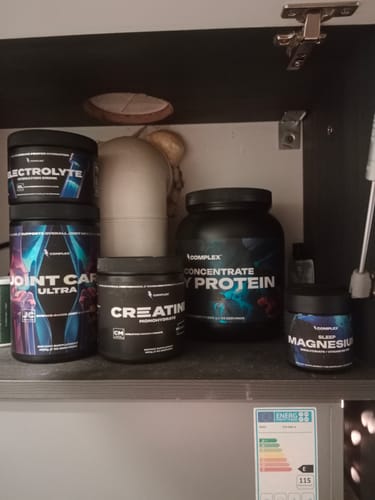 Customer's Joint Care Ultra supplement tub on a shelf among other fitness products.