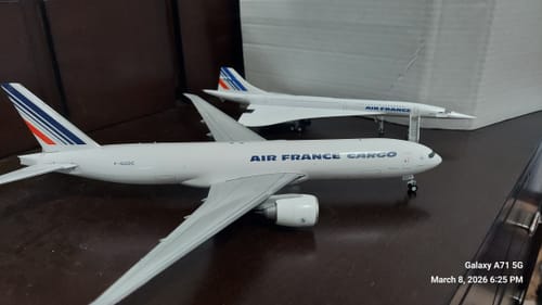Reviewer's GEMINI200 Air France Cargo 777F model airplane displayed on a dark surface next to another model.