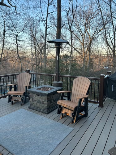 Customer's two two-toned Adirondack Single Gliders arranged on a deck around a fire pit.
