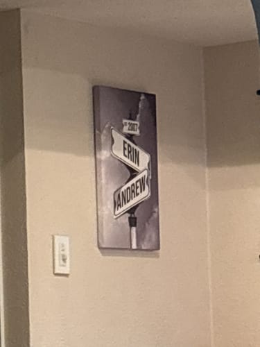 Customer's canvas print showing black and white street signs with the names 'Erin' and 'Andrew' on a wall.
