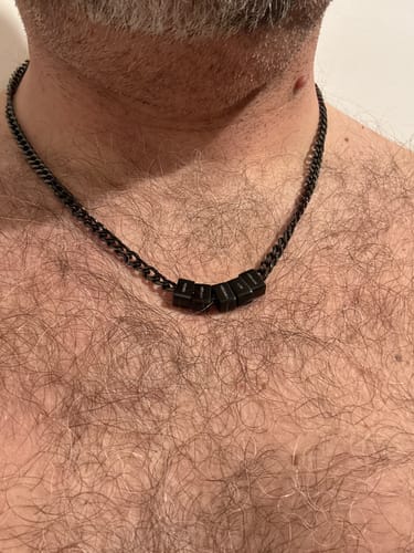 Customer wearing the black Legacy Necklace with several personalized beads around their neck.