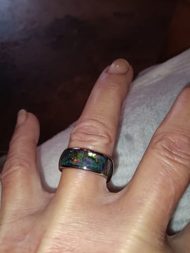 Customer wearing the Nerium ring, showing the iridescent abalone shell inlay on their finger.