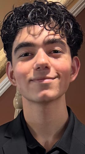 Reviewer with defined, curly hair after using the Leave-In Conditioner.