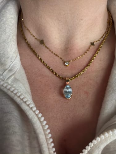 Customer wearing the gold Coco Rope Necklace with a personal charm, layered with a second delicate necklace.